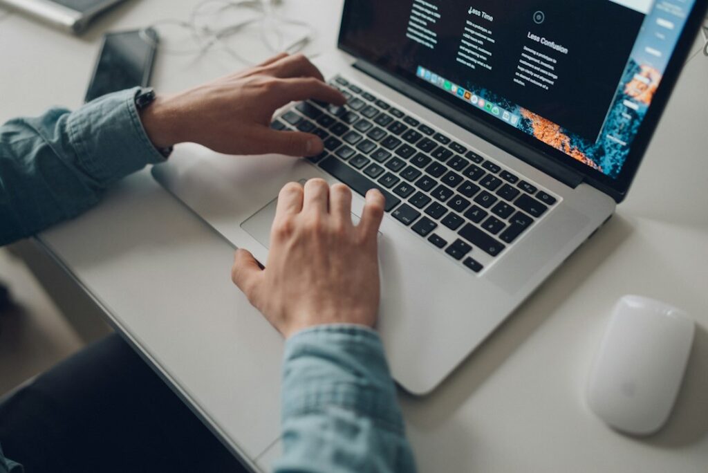 Manual Outreach SEO: Why It Beats Automated Link Building - person writing personalized email on laptop